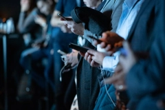 a group of people holding their phones