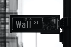 grayscale photo of Wall Street 1-21 street signage