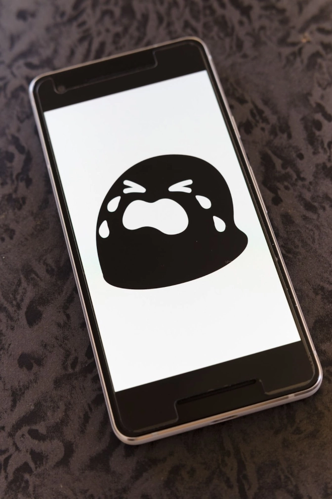 Black and White crying emoji on a mobile interface