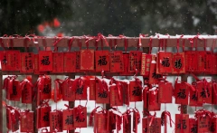 red packets tied to red fence using red string