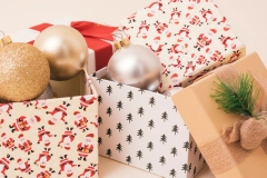 several bauble balls inside gift-wrapped cardboard boxes