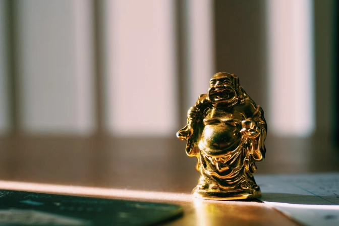 Small Budai, Laughing Buddha figurine on table