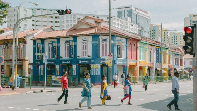 A group of people walking across a streetin Little India Singapore