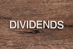 dividends letters on wooden background