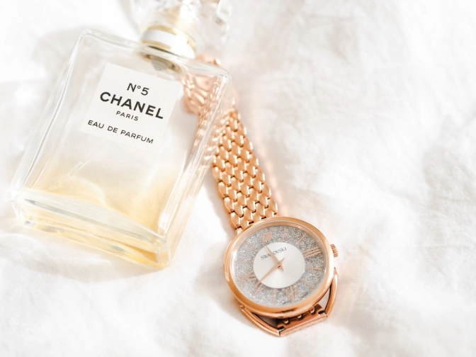 A champagne gold Swarovski watch and a Chanel Eau De Parfum&nbsp;