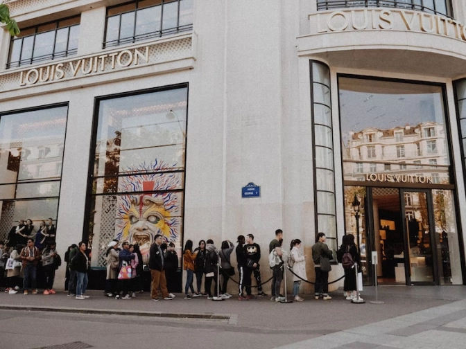 People queuing beside Louis Vitton store