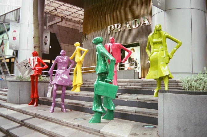 A group of colourfully dressed mannequins on the steps of a shopping mall singapore